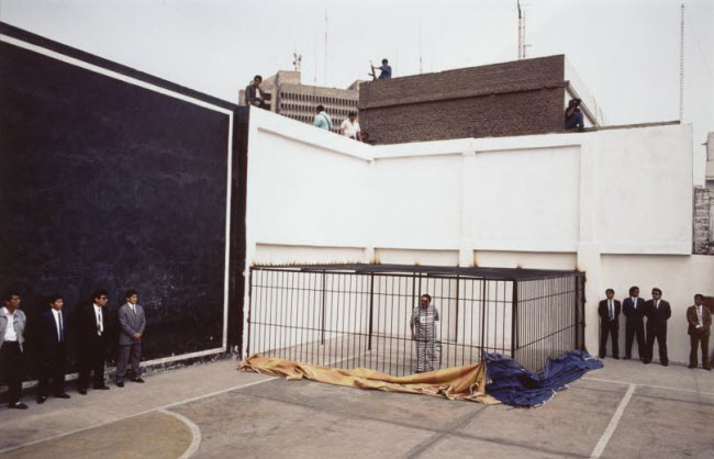 صورة عرض رجل العصابات البيروفي أبيميل جوزمان داخل قفص بطريقة إستعراضية أمام وسائل الإعلام