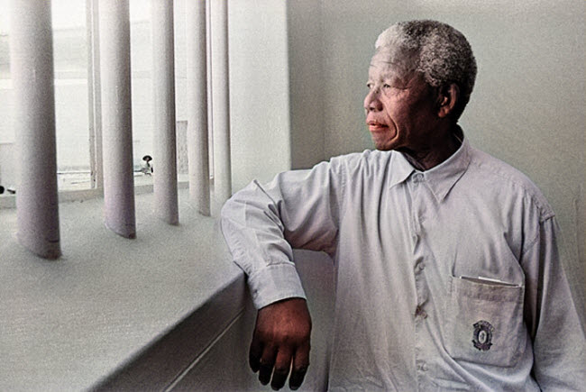 صورة الزعيم نيلسون مانديلا أثناء تأمله عبر قضبان زنزاته التى قضي حياته فيها معتقلا