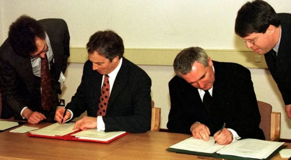رئيس الوزراء البريطاني توني بلير و رئيس الوزراء الأيرلندي بيرتي أهيرن أثناء توقيعهم على إتفاقية الجمعة العظيمة