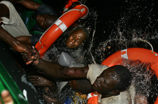 صورة إنقاذ عدد من المهاجرين الأفارقة بعد إنقلاب قاربهم في عرض البحر